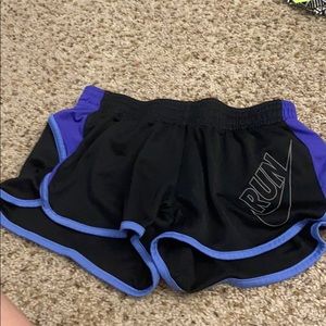 Black, light purple, and dark purple Nike shorts